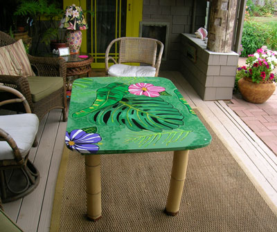 Patio table with leaf painted on it.